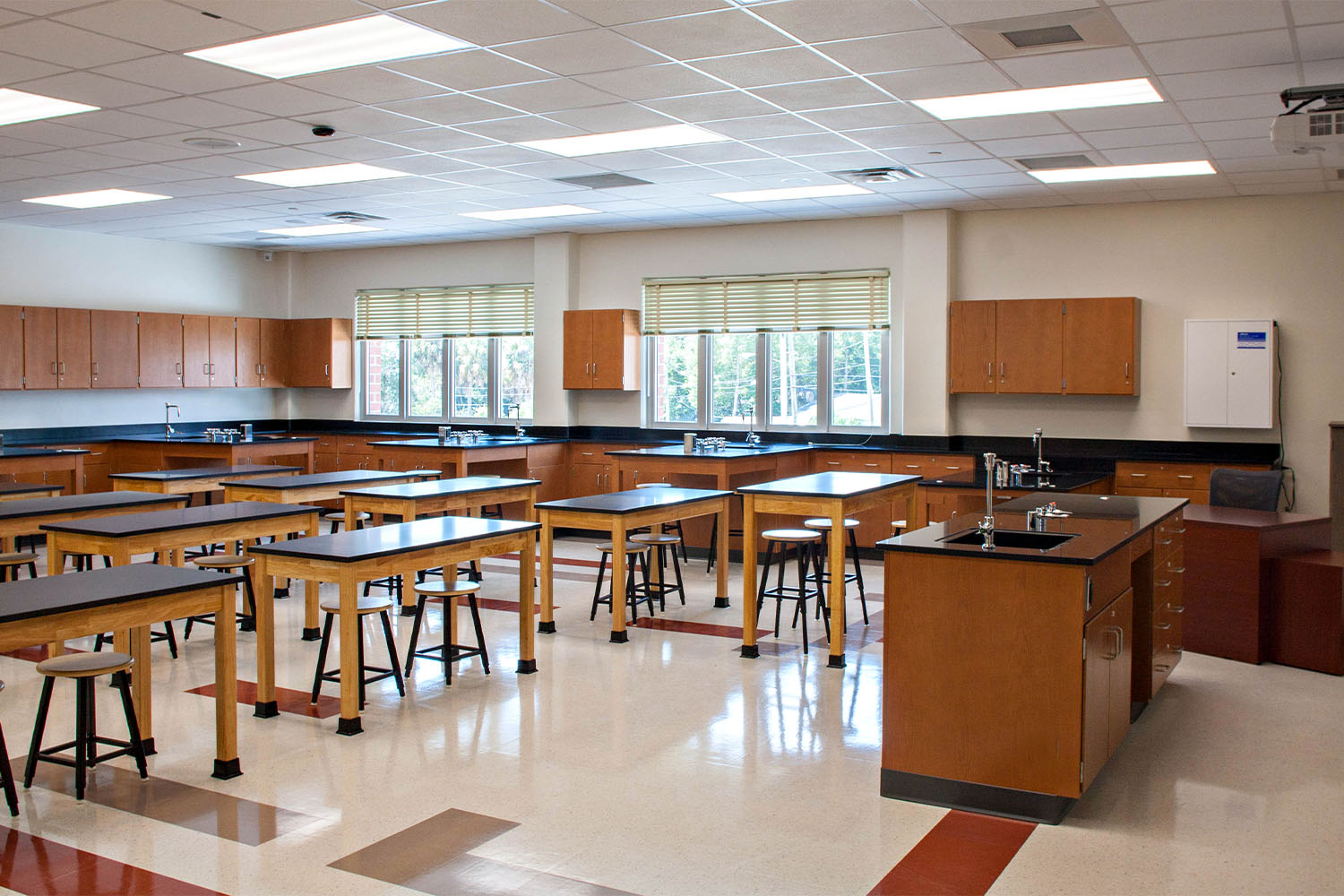New science lab with desks, wall storage and lab equipment