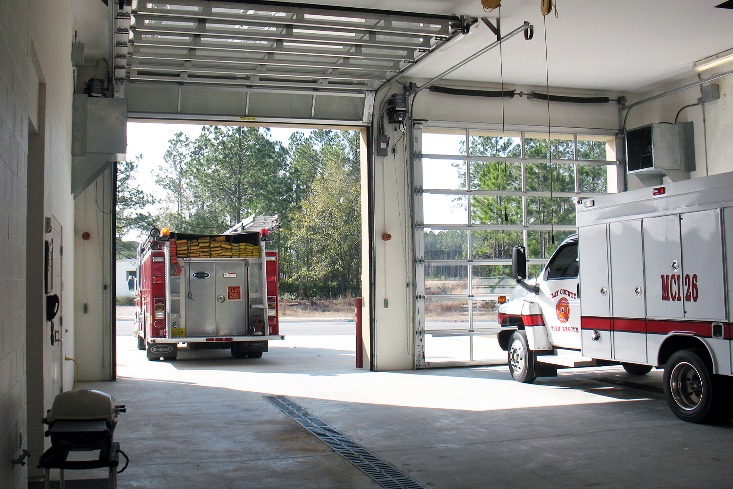 Interior view of the apparatus bay with a fire truck and rescue vehicle